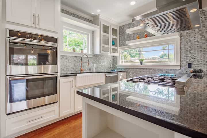 An image of a modern kitchen with sleek appliances, featuring a gas stove, refrigerator, and built-in microwave in Panama City